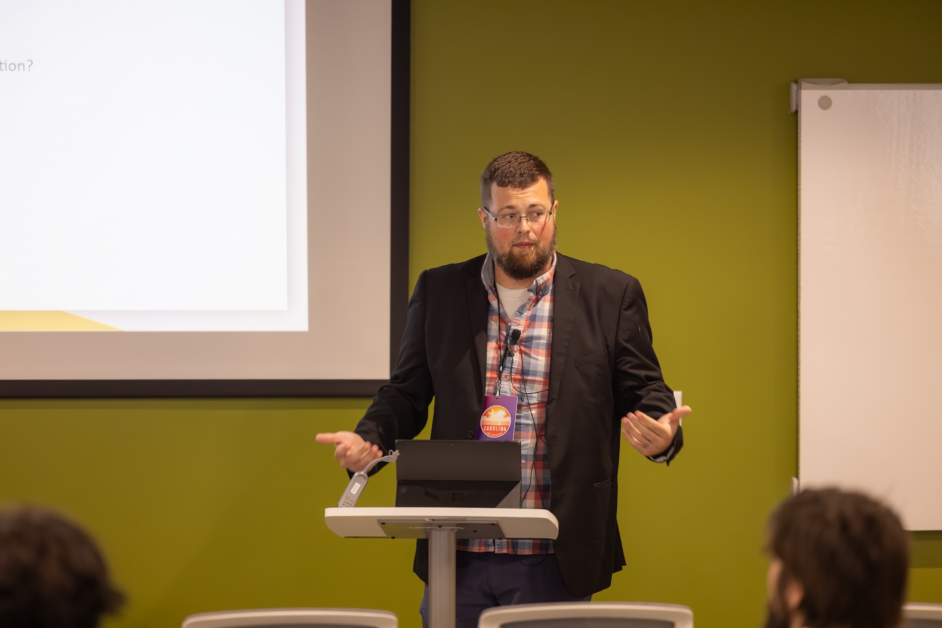Jake Hennett speaking at the 2024 Carolina Code Conference