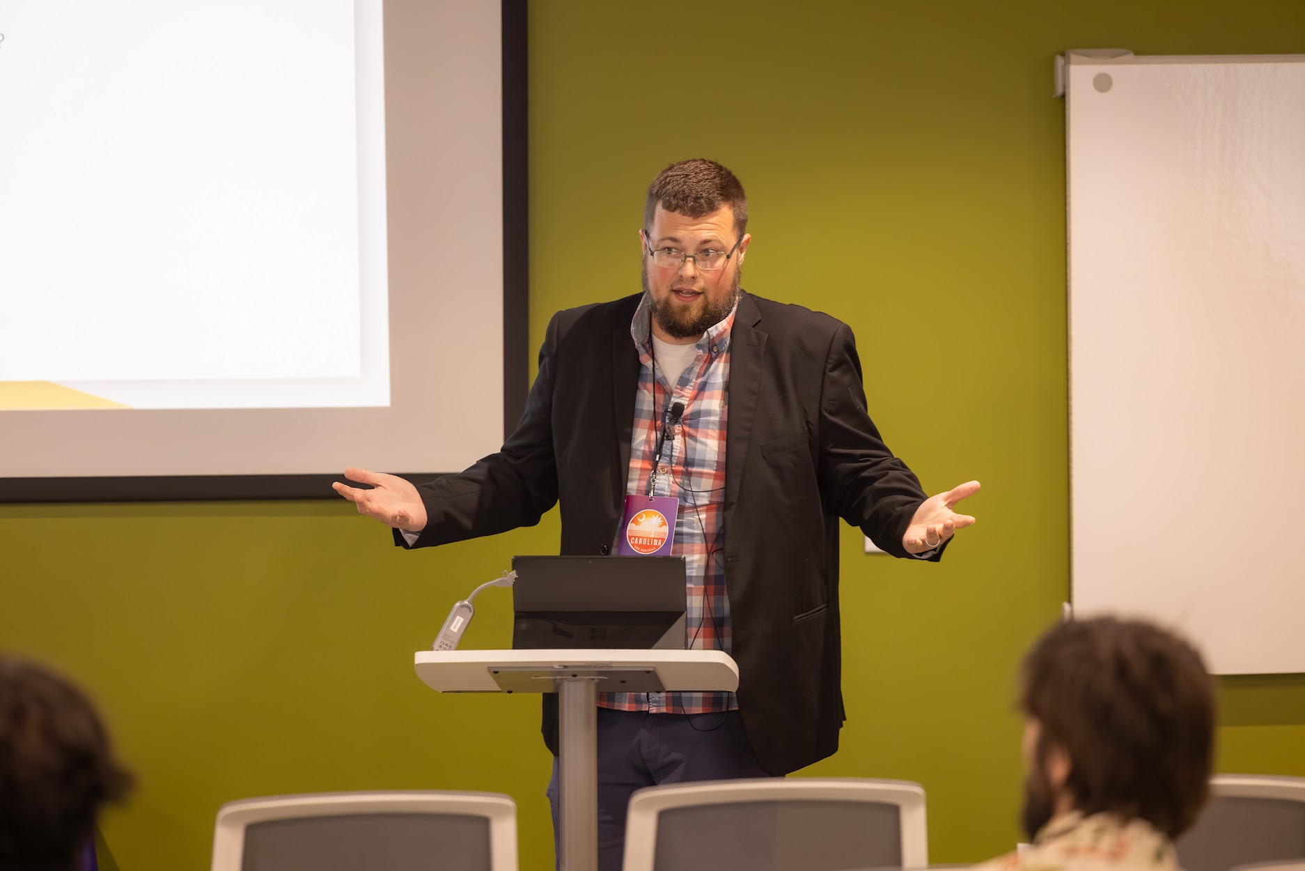 Jake Hennett speaking at the 2024 Carolina Code Conference