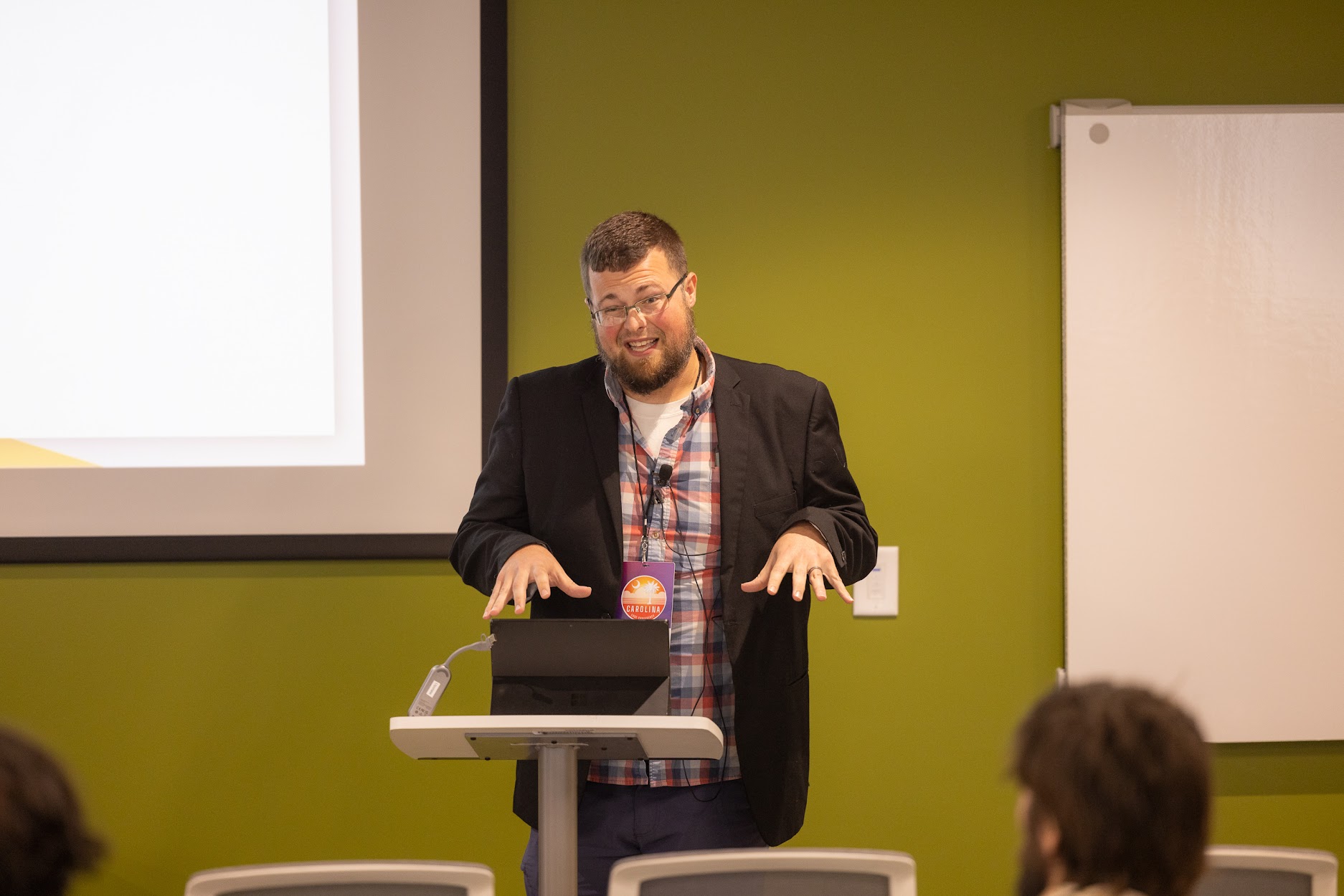 Jake Hennett speaking at the 2024 Carolina Code Conference