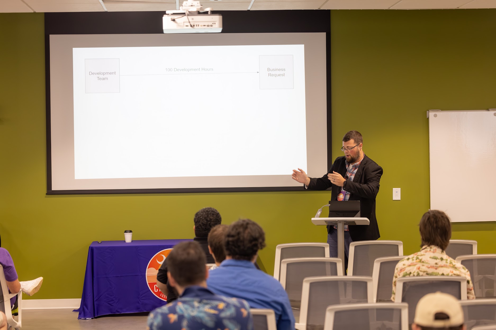 Jake Hennett speaking at the 2024 Carolina Code Conference