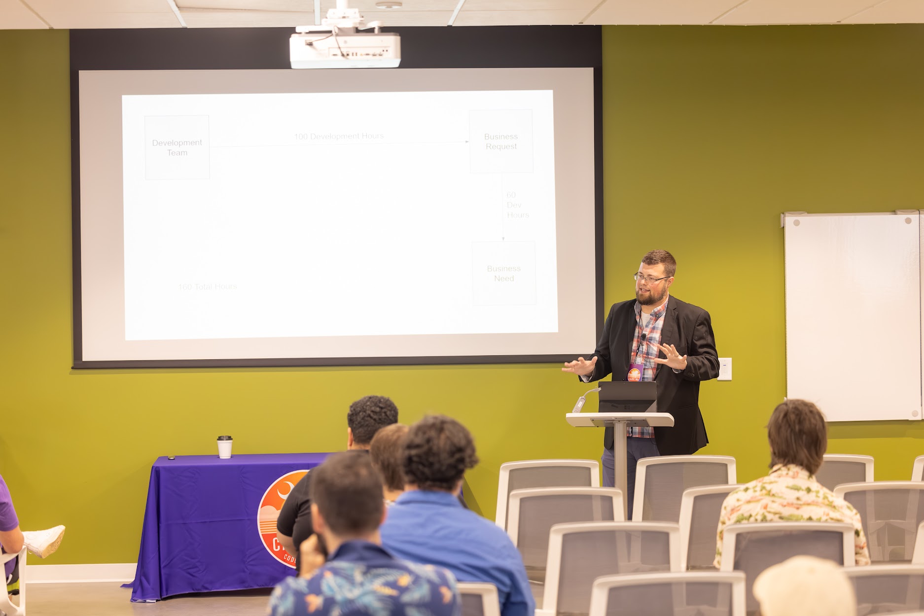 Jake Hennett speaking at the 2024 Carolina Code Conference