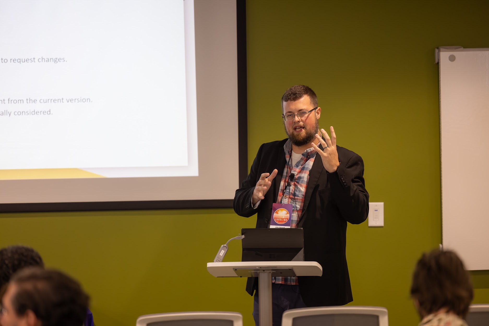 Jake Hennett speaking at the 2024 Carolina Code Conference